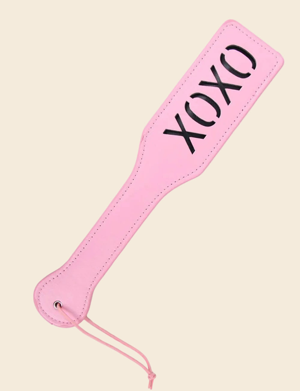 A pink paddle with the imprint 'XOXO' in black. The paddle has a sleek, flat design with a strap for holding.